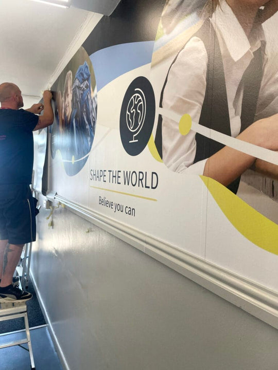 Installer applying Drytac Polar Grip Air wall graphics at Stonar School