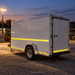 Illustrative application concept for reflective vinyl striping: work trailer striping at dusk. Scene colors are examples, not an exact White shade reference.