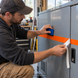 Illustrative application concept for reflective vinyl striping: vinyl stripe application in a workshop. Scene colors are examples, not an exact Yellow shade reference.