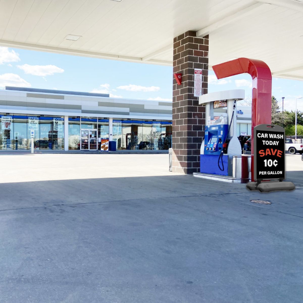 Gas station with a fuel pump and car wash sign on a clear day.