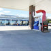 Gas station with a fuel pump and car wash sign on a clear day.