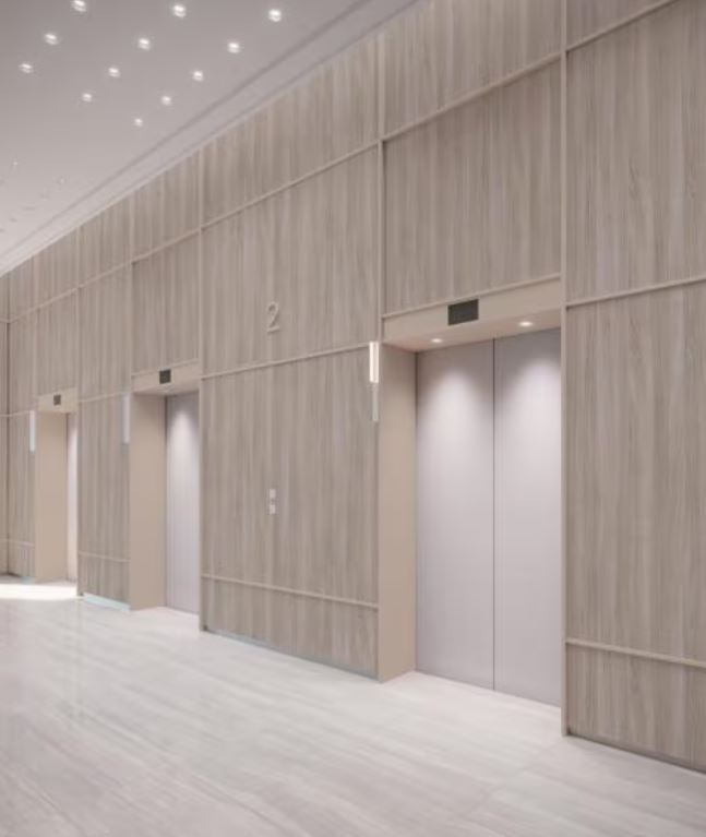 Modern elevator lobby with wooden panel walls and ceiling lights.