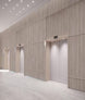 Modern elevator lobby with wooden panel walls and ceiling lights.