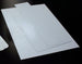 Two white sheets of paper on a black surface