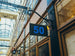 Building facade with a sign displaying the number 50 in an indoor setting with glass ceiling