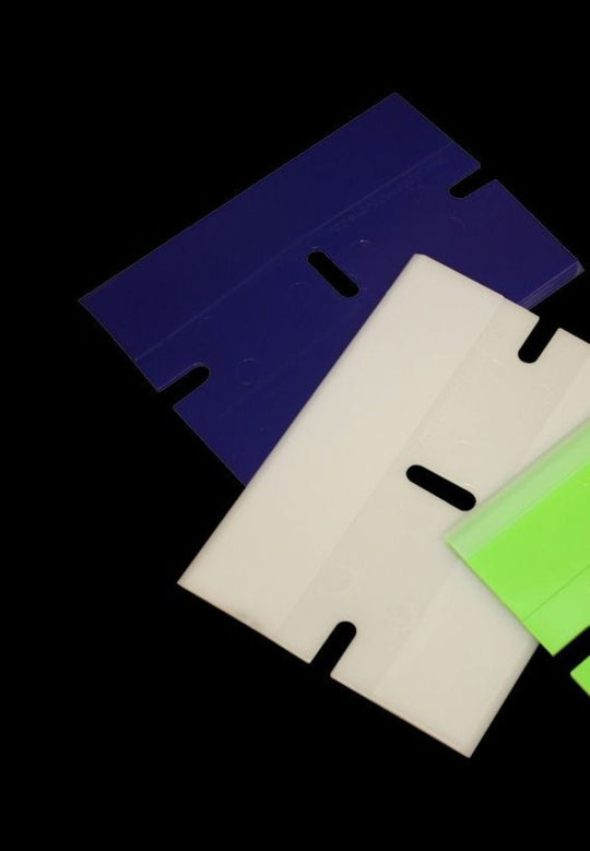 Three colorful plastic sheets with cut-out shapes on a black background