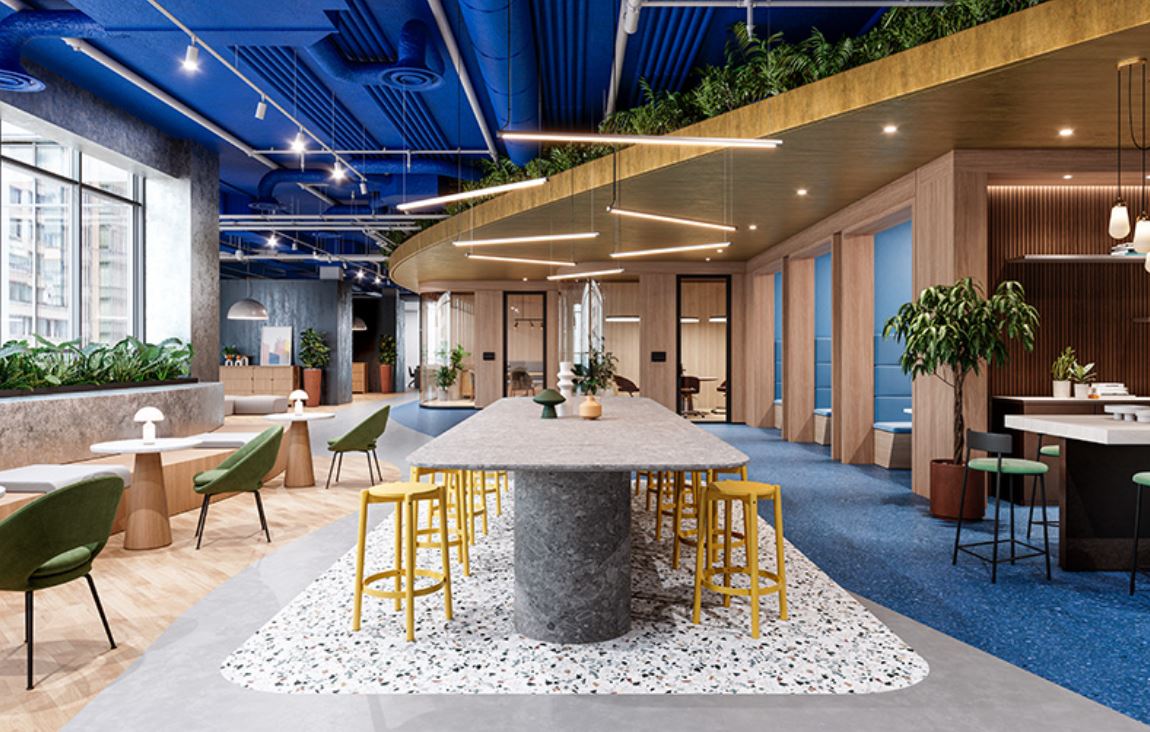 Modern office interior with a communal area featuring a large table and chairs.