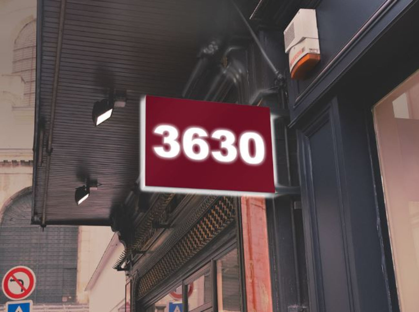 Burgundy sign with '3630' on a building exterior