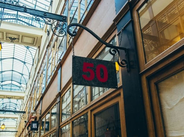 Building exterior with a sign displaying the number 50