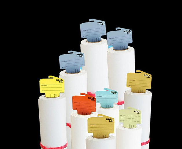 Stack of white bottles with colorful caps on a black background