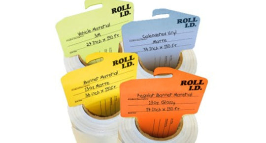 Three rolls of label material with colorful labels on a white background