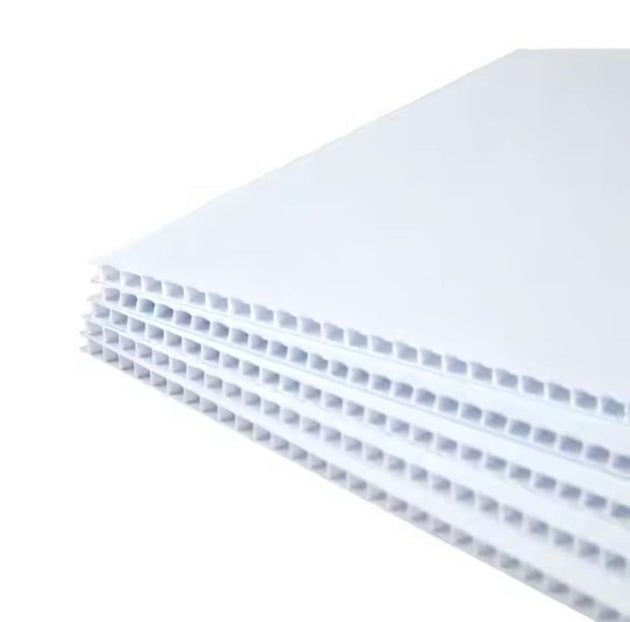 Stack of white honeycomb panels on a white background