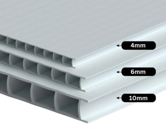 Stack of polycarbonate sheets with thickness labels on a gray background