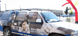 Van with a large advertisement on its side featuring multiple people.