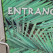 Glass door with palm leaf design and 'ENTRANCE' text