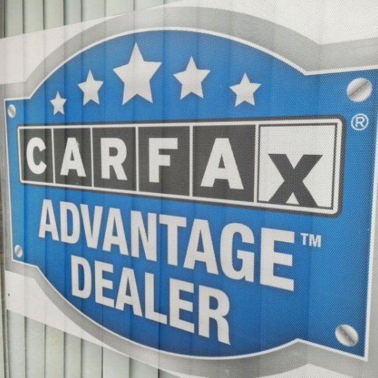 Carfax Advantage Dealer sign with blue background and white text