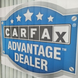 Carfax Advantage Dealer sign with blue background and white text