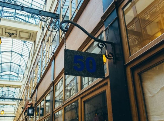 Building facade with number 50 sign in an indoor shopping arcade