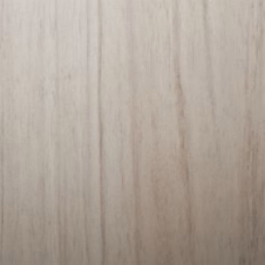 Close-up of a wooden surface with a light brown color and visible grain pattern.