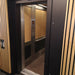 Elevator with wooden panel doors and metallic interior