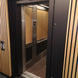 Elevator with wooden panel doors and metallic interior