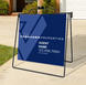 Real estate sign for Vanguard Properties with contact information on a stand outdoors.