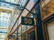 Building facade with a sign displaying the number 50 in an indoor setting with glass ceiling