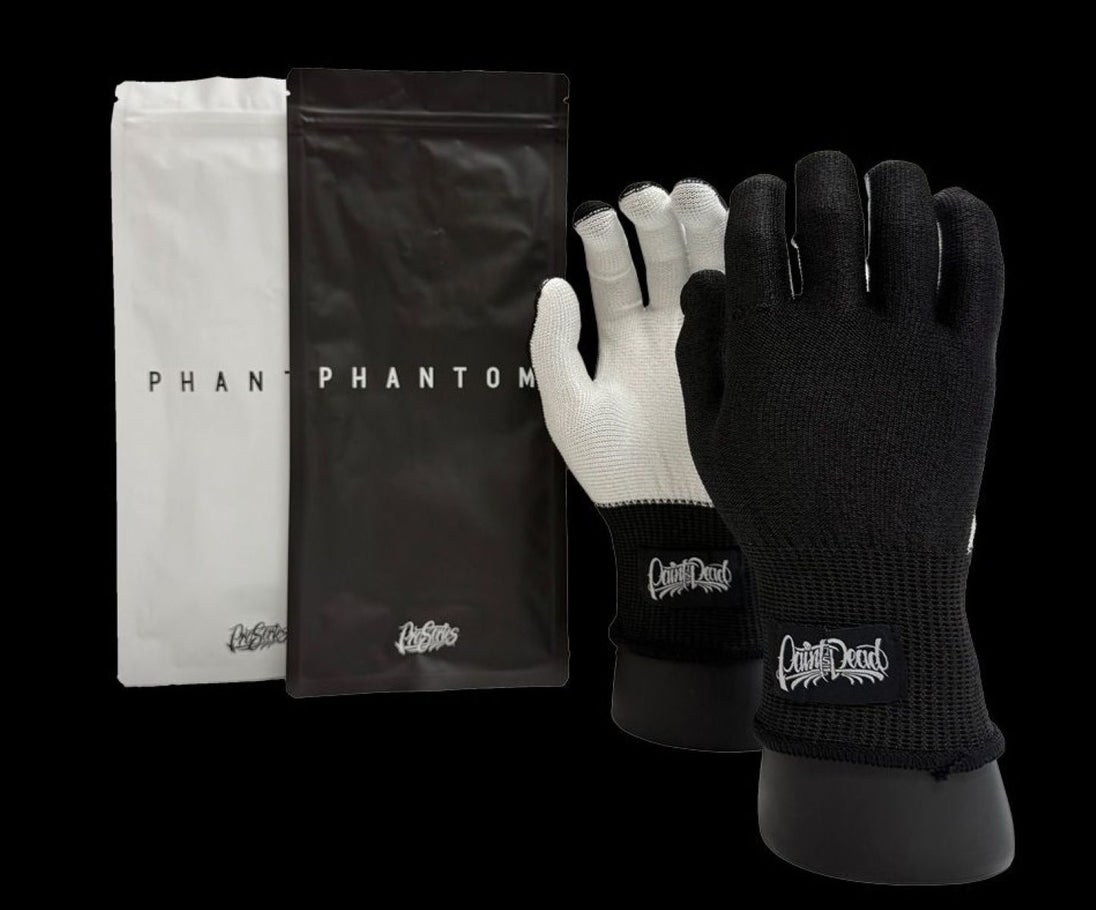Black and white gloves with 'Capital D' branding on a black background