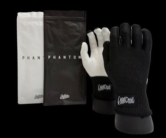 Black and white gloves with 'Capital D' branding on a black background
