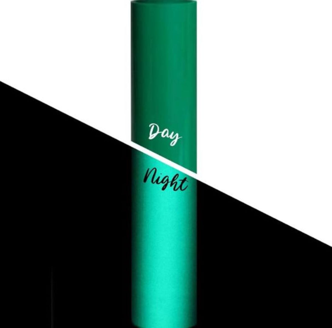 Green cylindrical container with 'Day' and 'Night' text on a black and white background