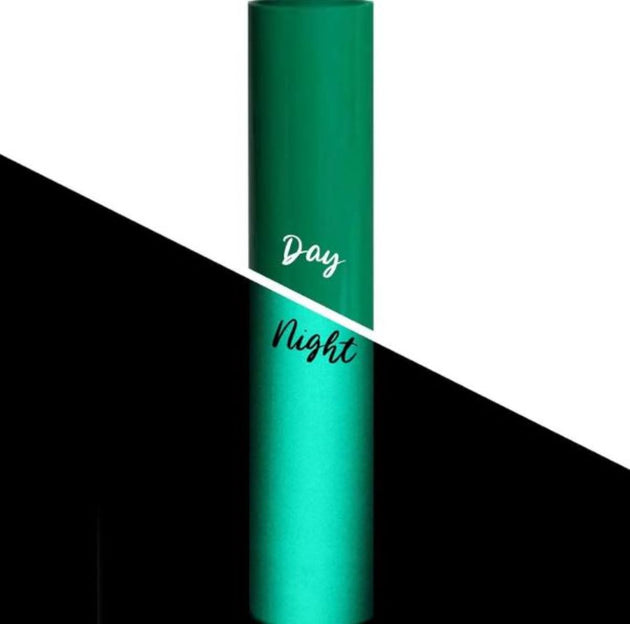 Green cylindrical container with 'Day' and 'Night' text on a black and white background