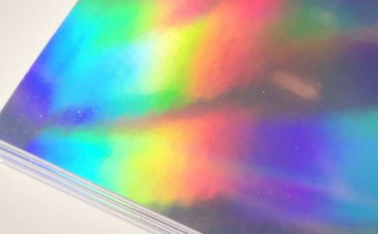 Sheet of colorful holographic paper with a rainbow effect.