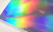 Sheet of colorful holographic paper with a rainbow effect.