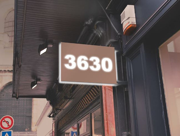 Building facade with a sign displaying the number '3630' on a street corner.