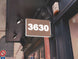 Building facade with a sign displaying the number '3630' on a street corner.