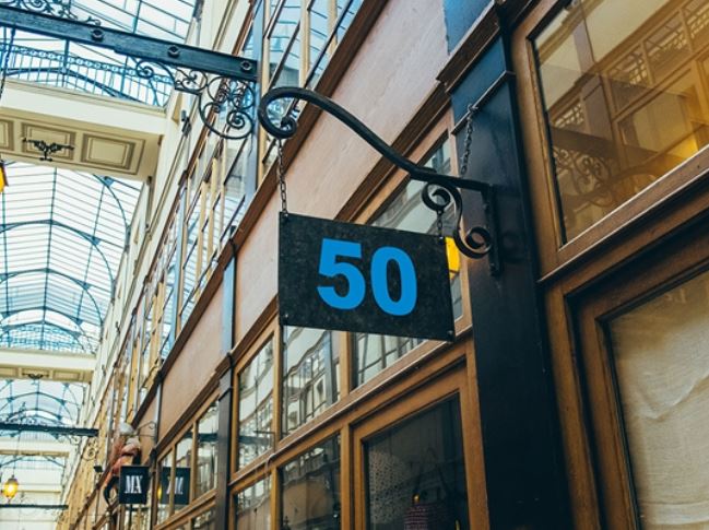 Building exterior with a sign displaying the number 50