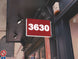 Red sign with '3630' on a building exterior