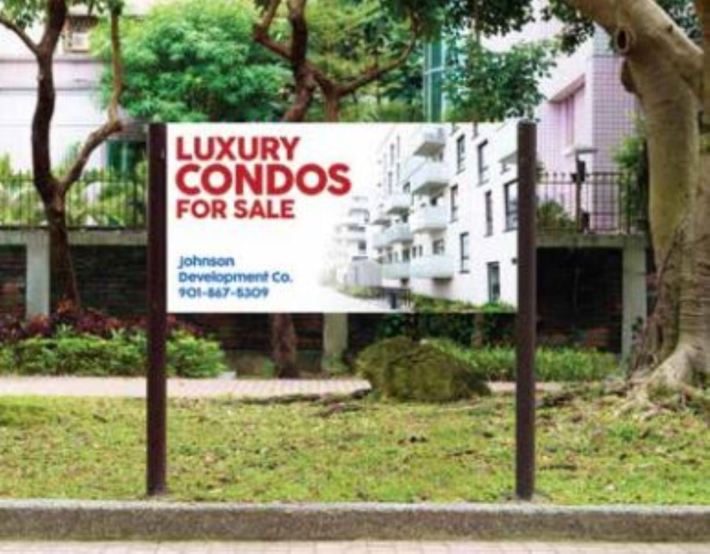 Real estate sign for luxury condos for sale in a residential area.