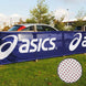 ASICS banner in an outdoor setting with a car in the background