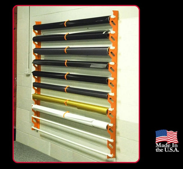 Wall-mounted rack holding various colored pipes with 'Made in the USA' label.
