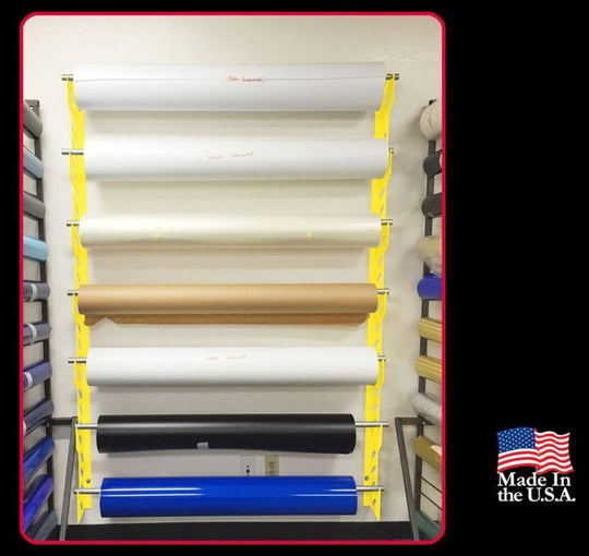 Rolls of fabric or paper on a rack with 'Made in the U.S.A.' label