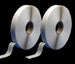 Two rolls of white tape on a black background