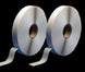 Two rolls of white tape on a black background