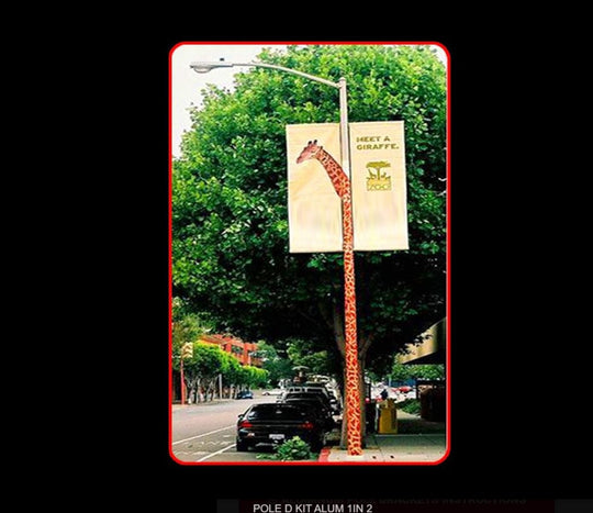 Giraffe-shaped street sign with a banner on a tree-lined street