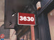 Red sign with the number 3630 on a building exterior