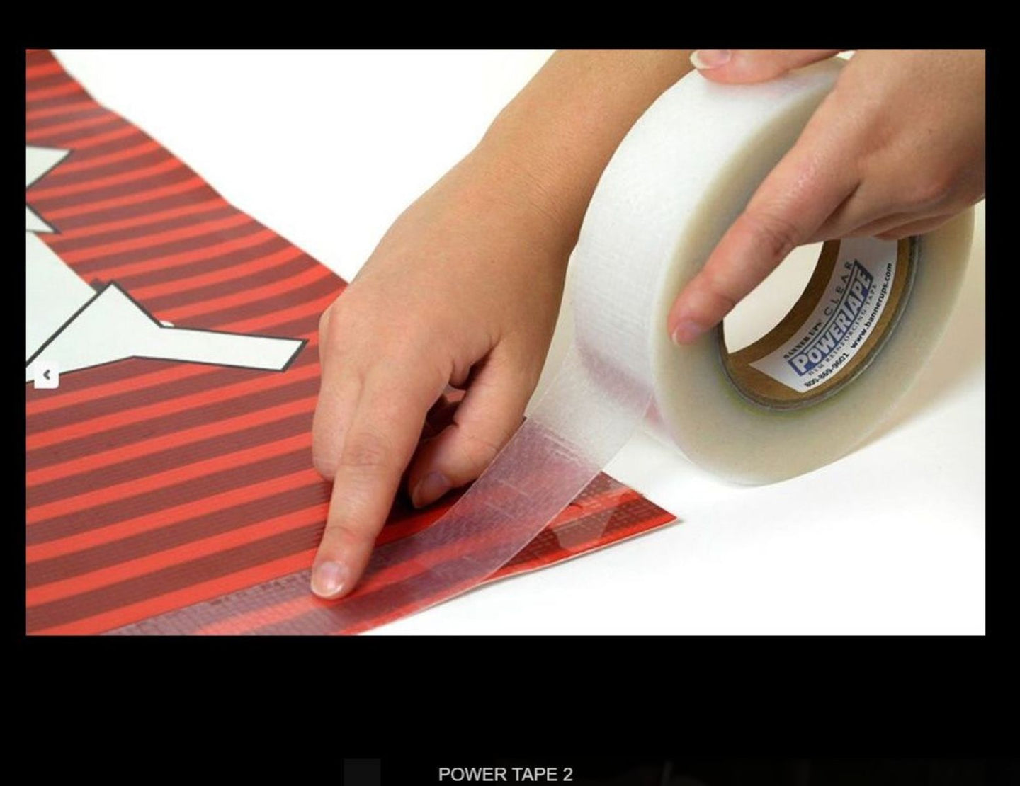Hand using Power Tape 2 on a red and white striped surface