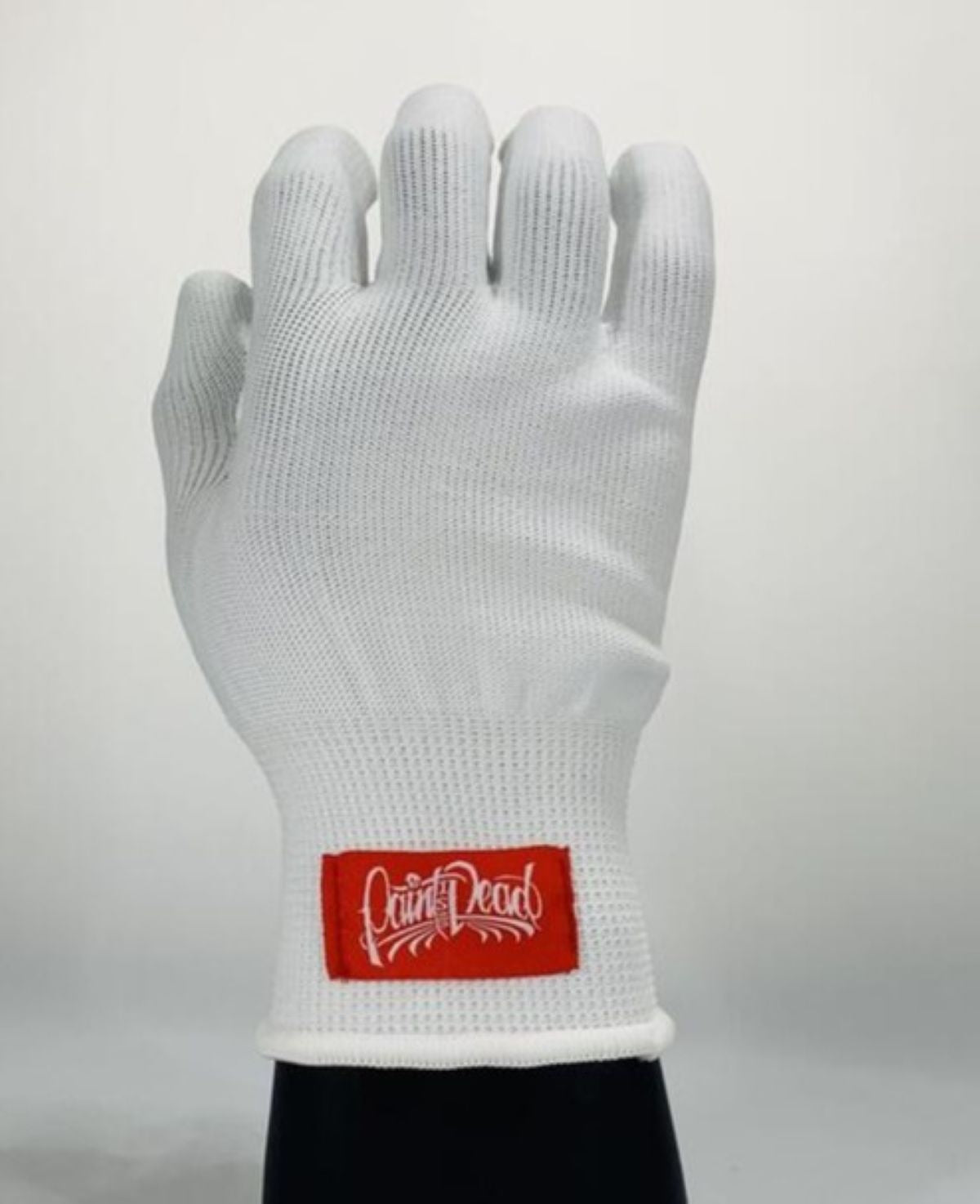 White glove with a red label on a light gray background