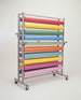 Roll storage rack with colorful rolls of paper on a white background
