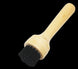 Wooden brush with black bristles on a white background