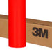Roll of red 3M vinyl wrap on a cardboard box with 3M branding.